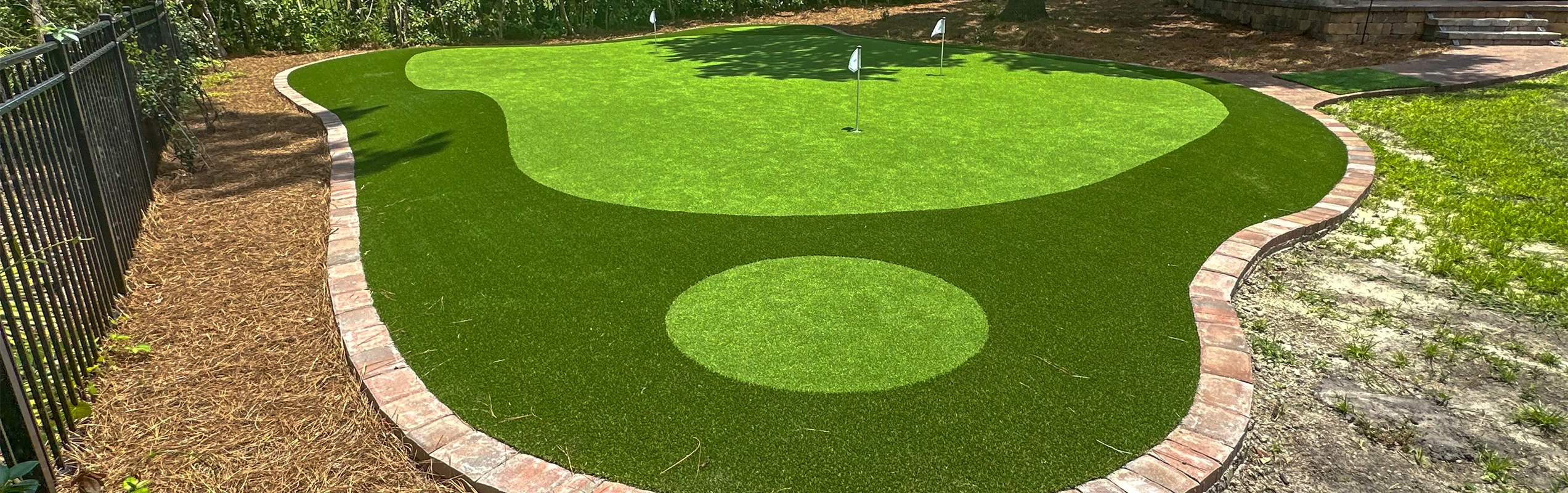 Backyard golf green installed by Jax Outdoor